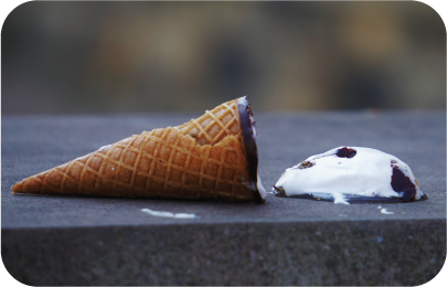 Vanilla ice cream cone dropped on a sidewalk, showing user error counts as a measurement of benchmark testing
