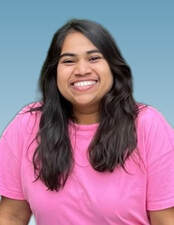 Head shot portrait of Prajakta Rampure smiling. She has brown hair and is wearing a pink blouse.