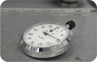 Stop watch laying face-up on the concrete, showing time as a measurement of benchmark testing.